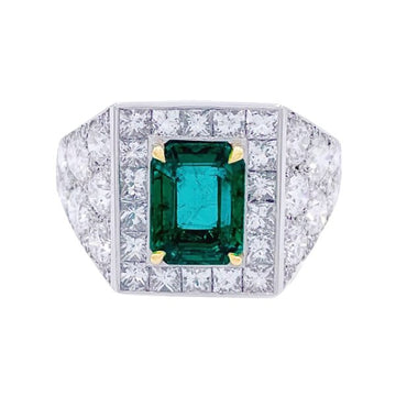 Platinum ring set with an emerald and diamonds.
